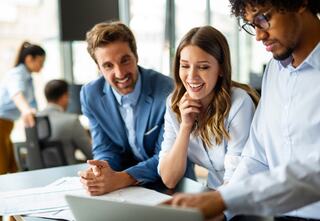 three team members reviewing documents together