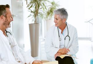 two doctors having a conversation in an open hospital space