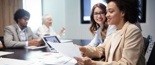 smiling office workers reviewing graphs