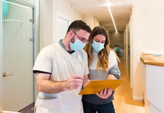 nurse explaining notes to female patient